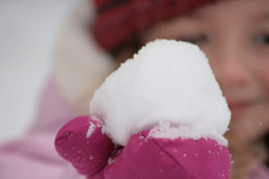 girl playing with snow