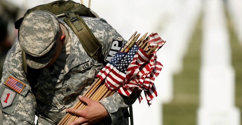 An American soldier honors the fallen on Memorial Day.