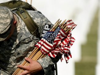 An American soldier honors the fallen on Memorial Day.