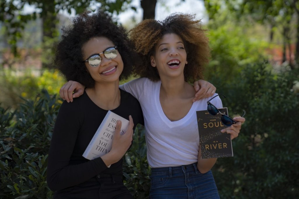 two black women holding books