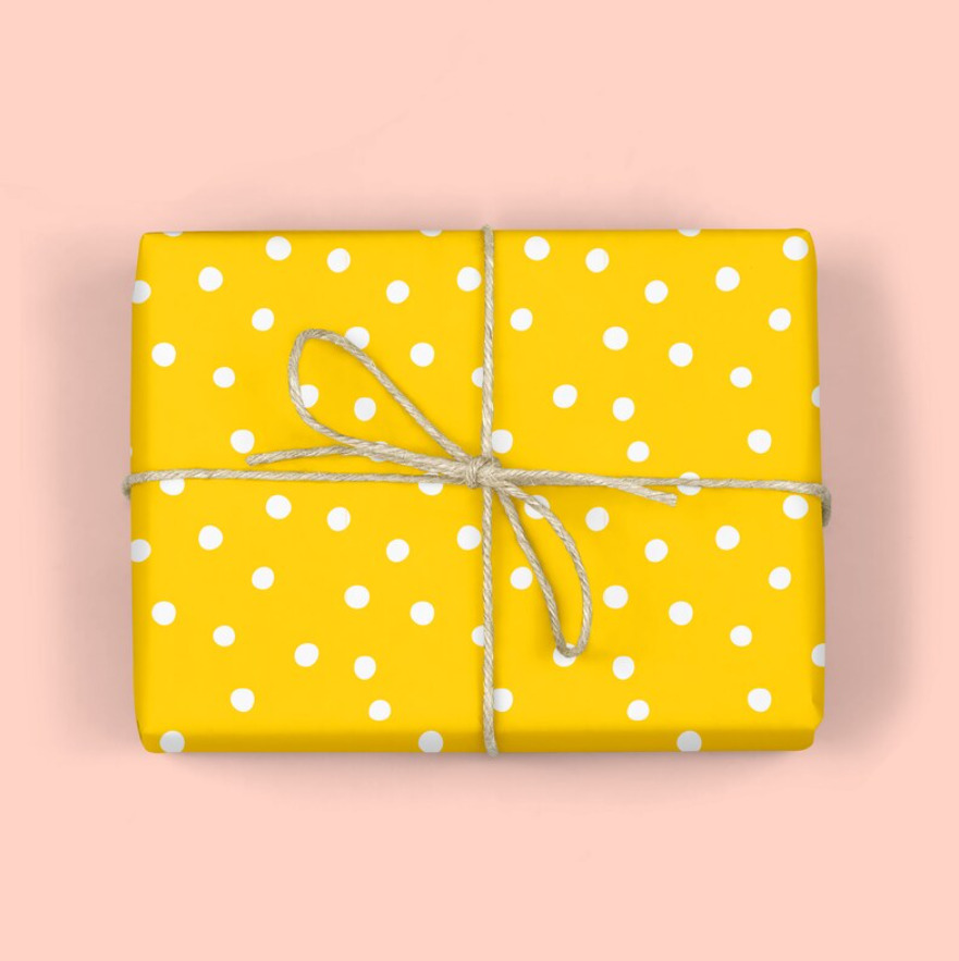 Yellow polka dot wrapping paper on gift box