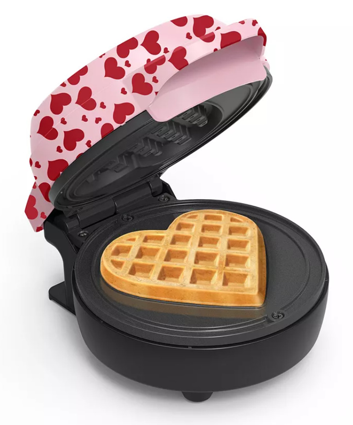 Mini heart shaped waffle maker with red hearts on cover