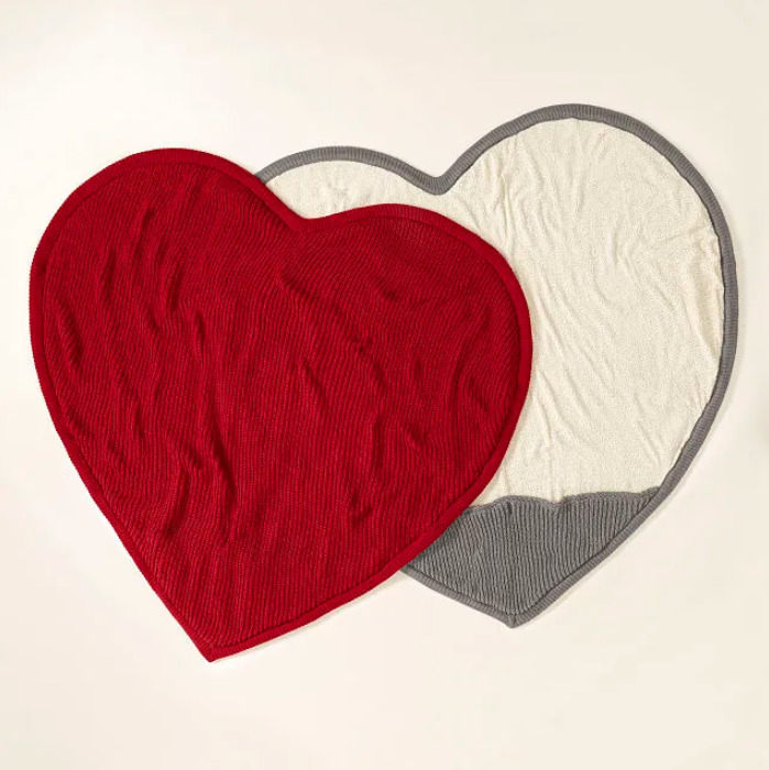 Red heart shaped blankets laid flat