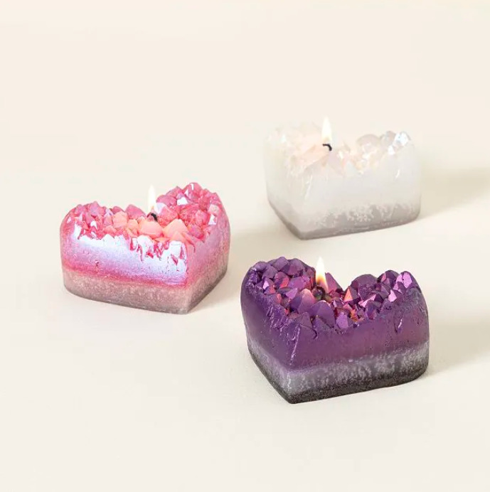 Purple amethyst geode heart-shaped candle with pink and white candle in background