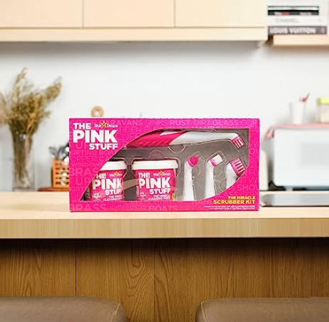 The Pink Stuff stain remover and scrubber kit on kitchen counter