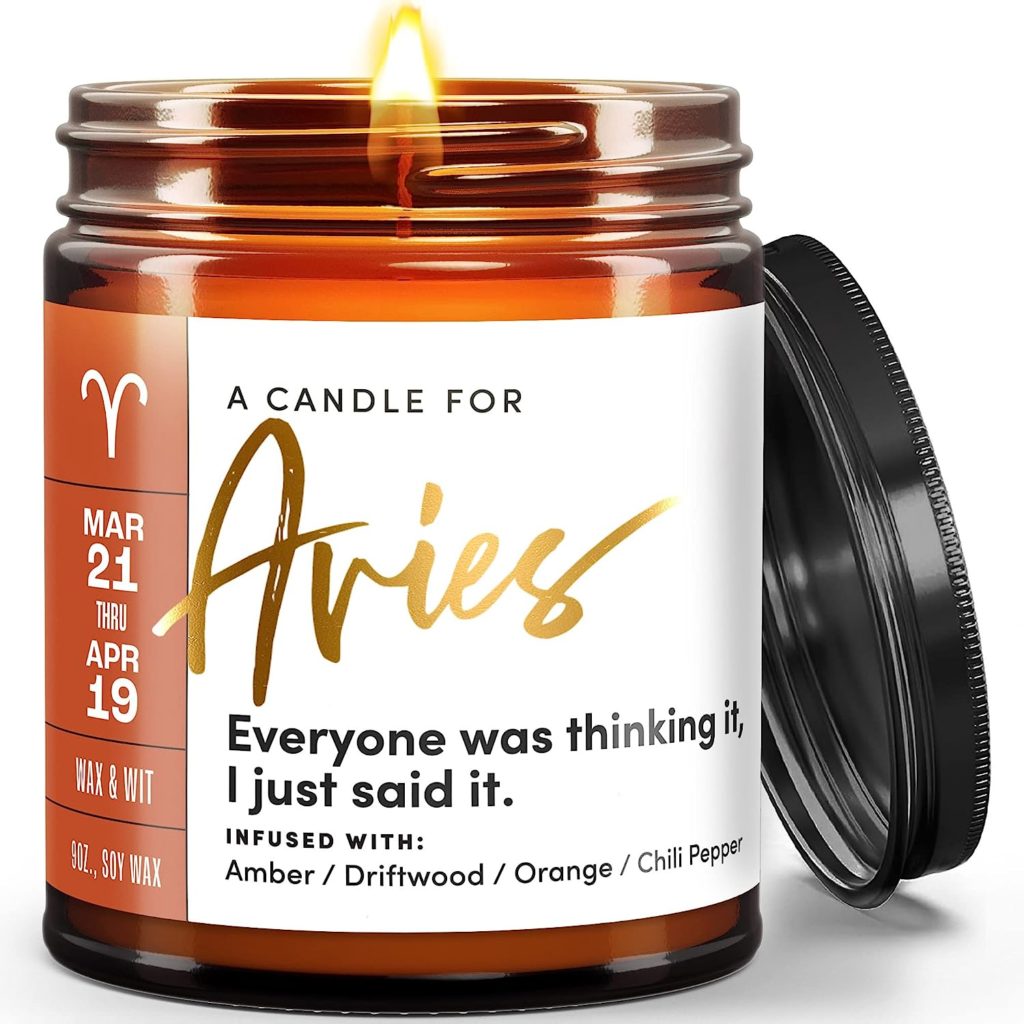 Candle in a jar with a label for Aries and description of their personality being honest