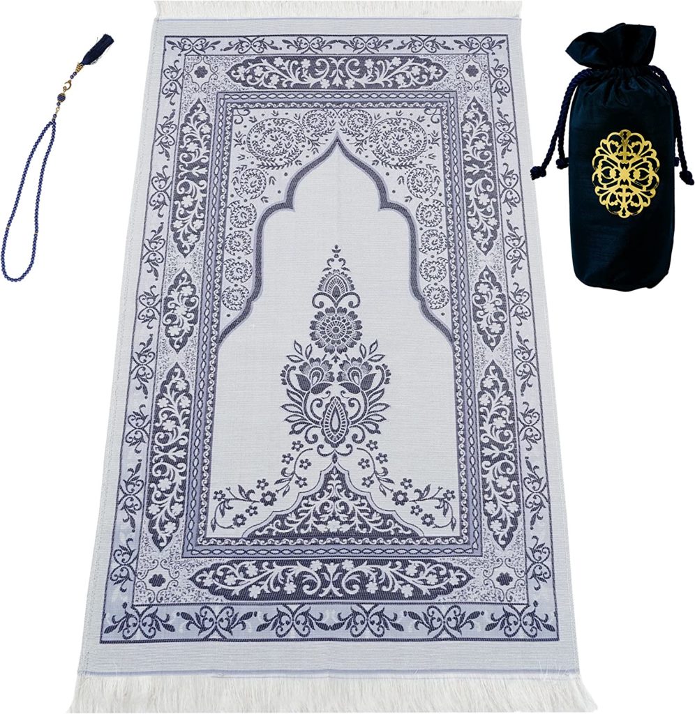 Muslim prayer rug with elaborate decoration with prayer beads and carrying bag