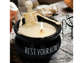 Plastic skeleton set into a black cauldron candle
