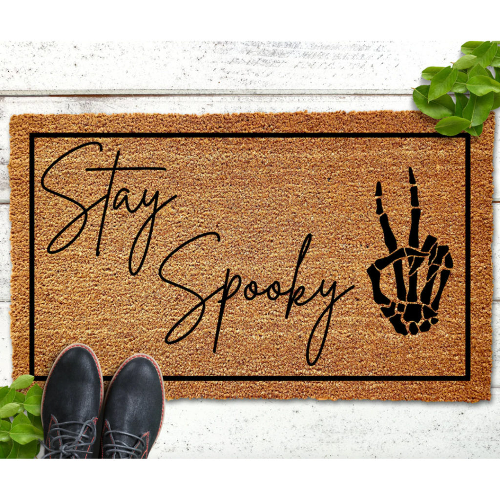 Stay Spooky doormat with skeleton hand for Halloween gift