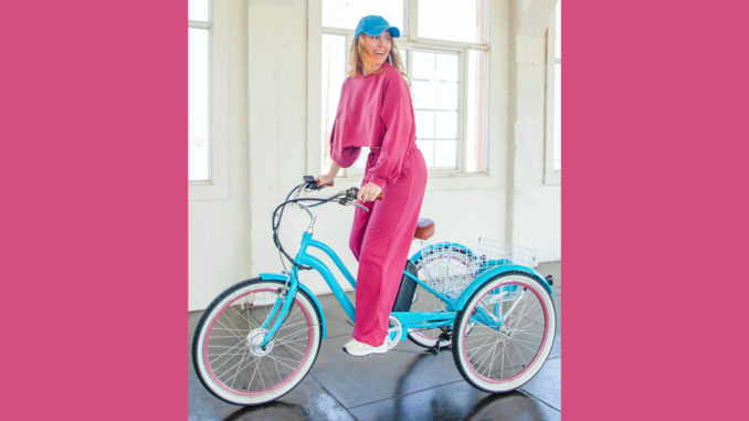 Smiling woman riding an electric tricycle
